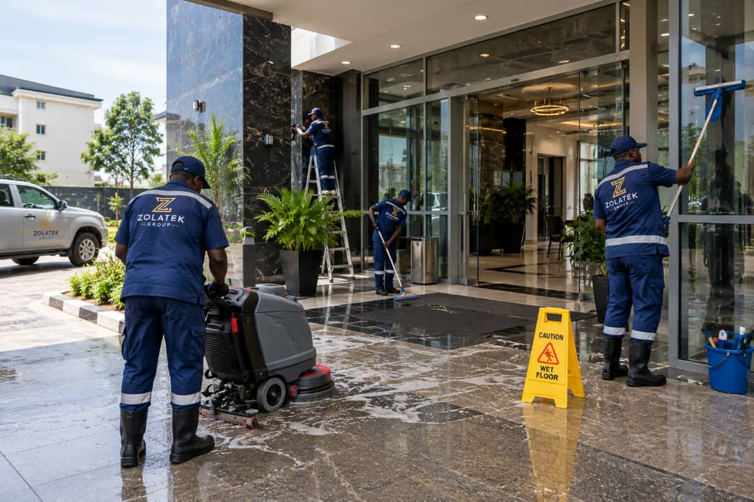Facility team cleaning and maintaining a commercial entrance